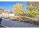 Landscaped backyard with storage shed and brick wall at 1646 S Winona Ct, Denver, CO 80219