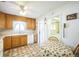 Bright kitchen with oak cabinets and tiled floor at 1646 S Winona Ct, Denver, CO 80219