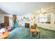 Living room with green carpet, wood accents, and staircase at 1646 S Winona Ct, Denver, CO 80219