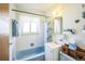 Clean bathroom with light blue bathtub and shower at 1646 S Winona Ct, Denver, CO 80219