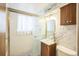 Modern bathroom with a pedestal sink and shower at 1646 S Winona Ct, Denver, CO 80219