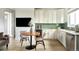 Small kitchenette with white cabinets and green tile backsplash at 16985 Black Rose Pl, Parker, CO 80134