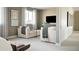 Upstairs sitting area with comfortable seating and a large TV at 16985 Black Rose Pl, Parker, CO 80134
