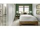 Cozy bedroom with green accent wall and en-suite bathroom at 16985 Black Rose Pl, Parker, CO 80134