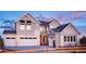 Two-story home with a neutral color palette and attached garage at 16985 Black Rose Pl, Parker, CO 80134