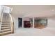 Finished basement with a staircase, piano, and mural at 8336 Vivian St, Arvada, CO 80005