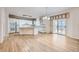 Bright kitchen with island, hardwood floors, and white cabinetry at 8336 Vivian St, Arvada, CO 80005