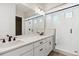 Elegant bathroom with double vanity, large mirror, and a walk-in shower at 4355 Hickory Oaks St, Castle Rock, CO 80104