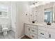 Bright bathroom featuring double vanity, white cabinets, and black fixtures at 4355 Hickory Oaks St, Castle Rock, CO 80104