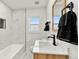 Bathroom with light wood vanity and marble tile at 5401 N Pecos St, Denver, CO 80221