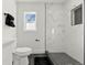 Clean bathroom, marble shower, dark gray floor tile at 5401 N Pecos St, Denver, CO 80221