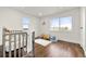 bedroom with hardwood floors and crib at 5401 N Pecos St, Denver, CO 80221