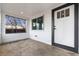 Enclosed front porch with concrete flooring and windows at 5401 N Pecos St, Denver, CO 80221