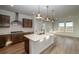 Modern kitchen with an island, stainless steel appliances, and dark wood cabinets at 23942 E 40Th Ave, Aurora, CO 80019