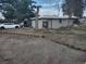 House exterior with gravel driveway and yard at 8730 Laurel Dr, Commerce City, CO 80022