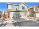 Two-story townhome with attached garage and small deck at 10475 W 82Nd Pl, Arvada, CO 80005