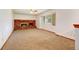 Bright living room featuring a brick fireplace and neutral carpeting at 1487 S Zeno Way, Aurora, CO 80017