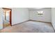 Empty bedroom with carpet, an open door to hallway and a window at 1487 S Zeno Way, Aurora, CO 80017