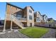 Landscaped backyard with artificial turf and deck at 992 Magnolia St, Erie, CO 80516