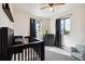 Cozy bedroom with a crib, dresser, and plenty of natural light at 352 Antelope Run, Elizabeth, CO 80107