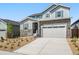 Two-story house with gray siding, stone accents, and a two-car garage at 1787 Water Birch Way, Castle Rock, CO 80108