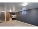 Finished basement with gray walls, carpeting, and a workspace at 6193 S Prescott St, Littleton, CO 80120