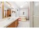 Main bathroom with a large bathtub, shower, and updated vanity at 9008 Madeleine St, Denver, CO 80260