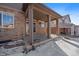 Covered patio with brick pillars, offering outdoor space at 23541 E Portland Way, Aurora, CO 80016