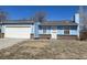 Ranch-style home with a blue exterior, attached garage, and small yard at 14425 E Albrook Dr, Denver, CO 80239