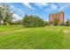 View of a grassy park with trees and a building in the background at 1000 E 1St Ave # 405, Denver, CO 80218