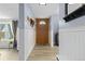 Bright entryway with wood floor and white wainscoting at 11827 Brook Rd, Golden, CO 80403