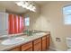 Dual vanity bathroom with large mirror and wood cabinets at 315 Venison Creek Dr, Monument, CO 80132