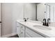 Modern bathroom with a double vanity, white quartz countertops, and dark fixtures at 1798 Marlowe W Cir, Erie, CO 80516