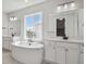 Elegant bathroom featuring a soaking tub and double vanity at 1798 Marlowe W Cir, Erie, CO 80516