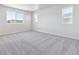 Spacious bedroom with neutral carpet and multiple windows at 8353 Vona Ln, Littleton, CO 80125