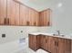 Laundry room with wood cabinets and a modern quartz countertop at 14560 N Navajo Ct, Broomfield, CO 80023