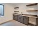 Modern wet bar in basement, featuring sleek cabinetry and floating shelves at 14560 N Navajo Ct, Broomfield, CO 80023