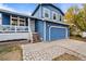 Two-story blue house with attached garage at 6140 E 121St Dr, Brighton, CO 80602