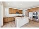 Modern kitchen with island, stainless steel appliances, and wood cabinets at 8389 Butte Creek St, Littleton, CO 80125