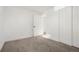Spacious basement bedroom with grey carpet and double closet at 7956 Joan Dr, Denver, CO 80221