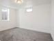 Clean, empty basement room featuring grey carpeting and a window at 7956 Joan Dr, Denver, CO 80221