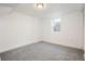 Bright, spacious basement room with grey carpet and a window at 7956 Joan Dr, Denver, CO 80221