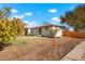Newly painted ranch home with a front yard and wooden fence at 7956 Joan Dr, Denver, CO 80221