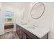 Double vanity bathroom with a view into a bedroom at 5173 Vivian St, Wheat Ridge, CO 80033