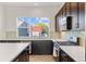 Modern kitchen with stainless steel appliances and white cabinets at 5173 Vivian St, Wheat Ridge, CO 80033