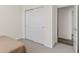 Bedroom with double doors leading to a closet and a view into the hallway at 5173 Vivian St, Wheat Ridge, CO 80033