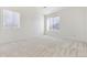 Spacious carpeted bedroom with two windows and neutral walls at 7409 S Alkire St # 305, Littleton, CO 80127