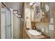 Clean bathroom with sink, shower, and mirrored cabinet at 85 Revett Dr # 73, Breckenridge, CO 80424