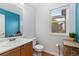 Clean bathroom with wood vanity and a window at 5863 S Gray St, Littleton, CO 80123