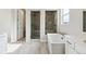 Luxurious bathroom with a large bathtub and walk-in showers at 5566 Hickory Oaks Trl, Castle Rock, CO 80104